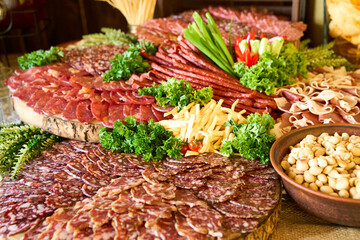 Delicious charcuterie spread featuring a variety of meats, cheeses, and fresh garnishes arranged beautifully on wooden boards