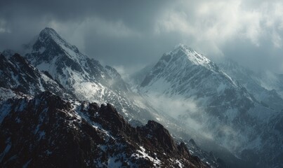 Snowy mountain peaks piercing a dramatic sky
