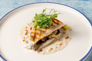 Grilled sea bream fillet served with creamy white sauce