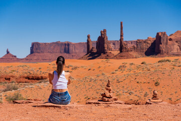 Unrecognizable Young Woman Looking at Monument Valley Columns