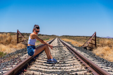 A Young Woman on Solitary Train Tracks in Arizona, USA