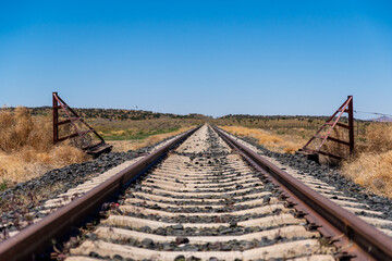 Solitary Train Track in Arizona with Cattle Guard Fence