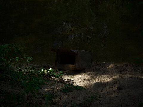 abandonned microwave on the beach by the river