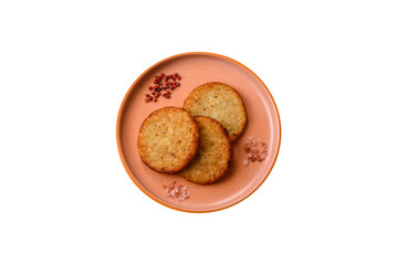 Hash browns, fried potato and onion pancakes with spices for breakfast. Fried hash browns