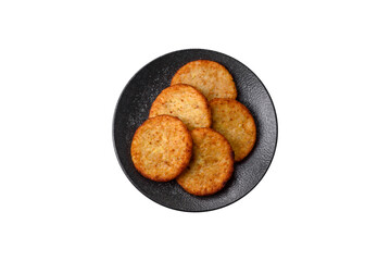 Hash browns, fried potato and onion pancakes with spices for breakfast. Fried hash browns