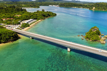 Side Aerial View of Kouri Bridge (古宇利大橋) over Coral Reef Lagoon, Okinawa, Japan