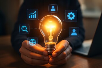 Person holding a glowing light bulb surrounded by digital icons representing business and technology concepts