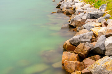 Long exposure background of rocks by the water