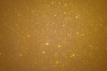 Golden glitter texture creating a shimmering background.