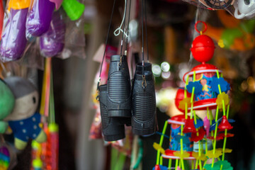 Closeup of various colorful toys hanging in a market stall