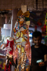 Colorful fabric hair accessory with bow displayed at market stall