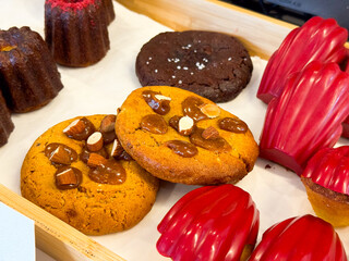 Variety of baked goods including canale, cookies, and pastries. Sweet flavors, bakery tradition,...