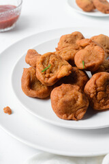 Overhead view of Akara on a white plate, top view of Brazilian acaraje fried beans cake on a plate