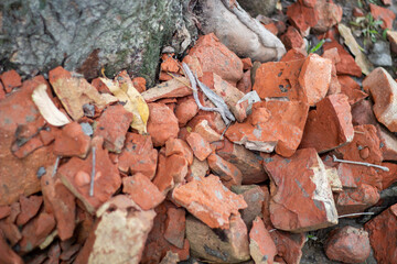 Pile of broken red bricks and debris on the ground