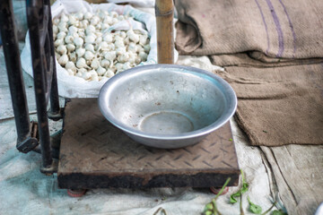 Old metal weighing scale with a bowl and produce in the background