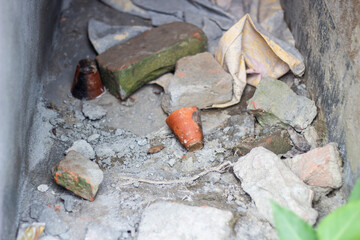 Pile of bricks and debris in a concrete ditch