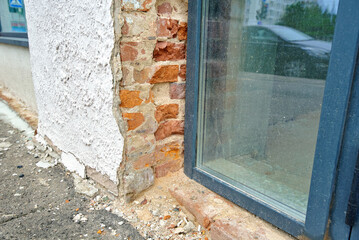 Restoration of building facade including door and window replacement, repair after damage to...