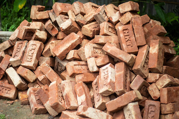 Pile of red clay bricks for construction