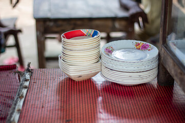 Stack of plates and bowls on a red checkered table
