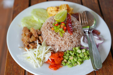 Tradition thai food : Nam prig Kapi is shrimp paste mix chili sauce served with boiled and fresh vegetables the table. Steamed rice and boiled egg served with fried fish and shrimp paste. Popular food