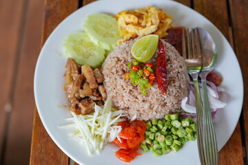 Tradition thai food : Nam prig Kapi is shrimp paste mix chili sauce served with boiled and fresh vegetables the table. Steamed rice and boiled egg served with fried fish and shrimp paste. Popular food