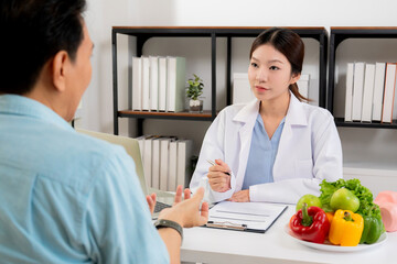 Asian nutritionist consulting patient in clinic, meal plan discussion, healthcare advice, weight loss support, doctor talking and explaining patient for nutrition consultation, wellness care.