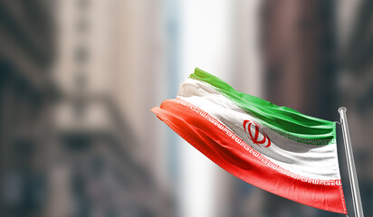 Iran national flag waving on street. A beautiful with mast with blur buildings. Iran national flag...