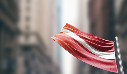 Latvia national flag waving on street. A beautiful with mast with blur buildings. Latvia national...