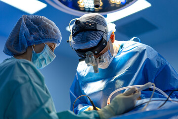 Surgeons operating in hospital. Medical professionals in surgical attire operate with precision...