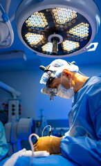 Surgeon in delicate surgery. Surgeon focuses intently on a surgical procedure in a bright operating room equipped with modern technology.