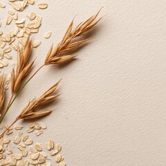 Beige background with scattered oat flakes and dried oat stalks arranged diagonally, leaving ample space