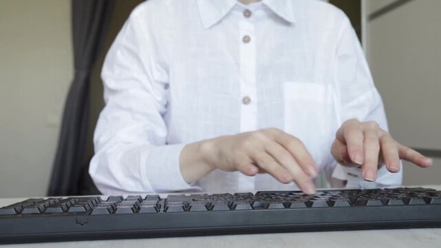Home office or student workspace scene, person engaged in typing session, suggesting data entry, communication, or writing tas