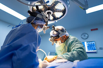 Surgeons in the or. Medical professionals focused on a surgical procedure in a well-equipped...