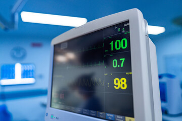 Patient data on monitor. A vital signs monitor shows patient's heart rate, oxygen level, and other important metrics in a hospital setting.