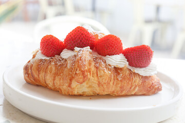 strawberry and fresh cream croissant on plate