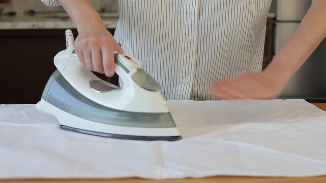 Woman hands ironing clothes