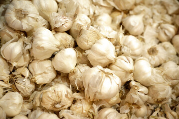 Basket full of fresh garlic bulbs on market display