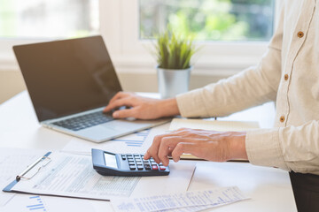 Account finance, asian young business man hand using calculator, laptop computer for calculate...