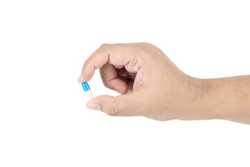 Man's hand holding a medicine capsule pill for health and treatment, isolated on white background with clipping path.
