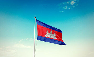 Cambodia national flag waving in blue sky.