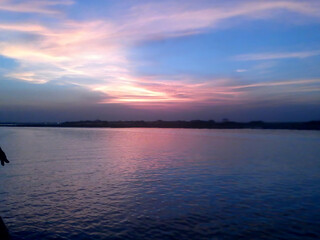 Fototapeta premium Beautiful sunset over river with colorful sky reflection