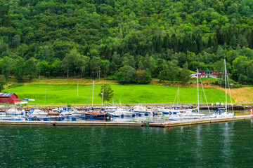 Fototapeta premium Yachts and boats mooned on the shore of Sognefjord, Norway