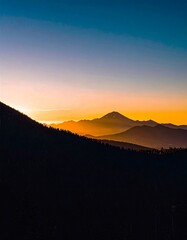 Majestic Mountain Range Silhouetted Against a Vibrant Sunset Sky