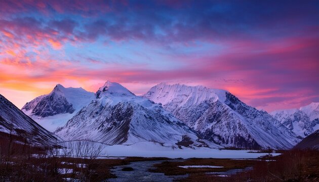 majestic snow capped mountains under a vibrant pink and purple sky at twilight