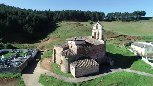 Aerial view of the Church of San Juan Bautista in Nogales de Pisuerga, Palencia, with cemetery and hillside