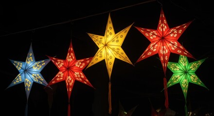 Colorful illuminated star lanterns hanging at night