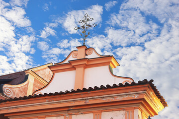 The top of the building with an exquisite cross, Cesky Krumlov, Czech Republic. Entrance to Minorite Monastery, Cesky Krumlov, Czech Republic
