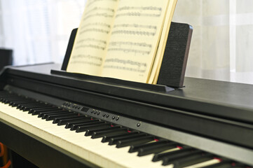 Open music score on digital piano, showcasing melody creation and artistic expression. music score is foundation of every beautiful composition.