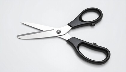 Pair of stainless steel scissors with black ergonomic handles, positioned open on a clean surface