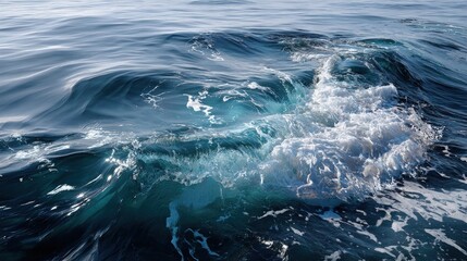 Fototapeta premium A close-up view of powerful ocean waves, exhibiting dynamic textures and varying shades of deep blue and white foam, capturing the raw beauty and energy of the sea.